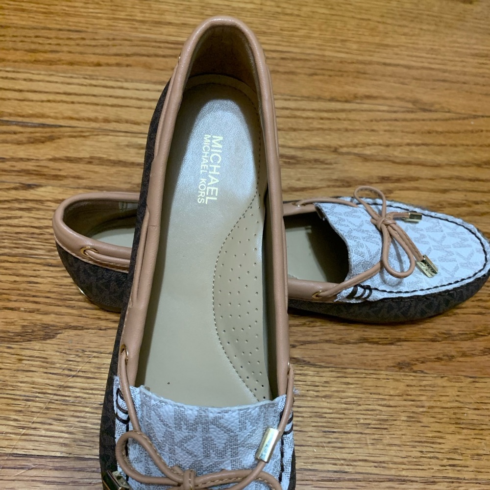 Michael Kors logo loafers.
